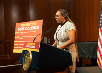 GOSO/SAVE's Nicole Myers speaks at podium during bill signing